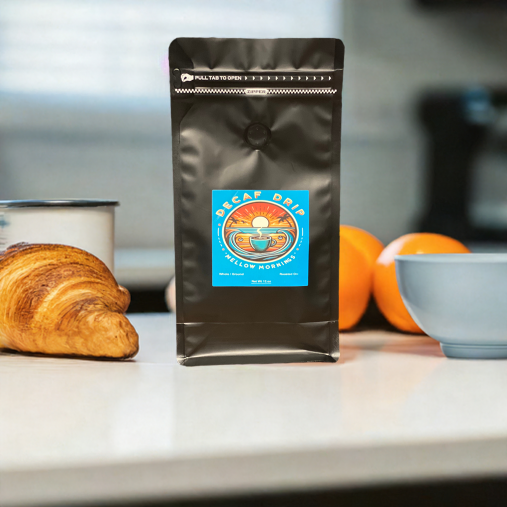 A package of coffee beans with the label 'Mellow Mornings' on a table, with scattered beans and a plant backdrop.